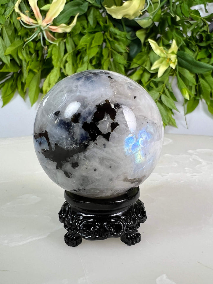 Maansteen bol 2 met blauwe flash op zwarte bolhouder design met pootjes.
